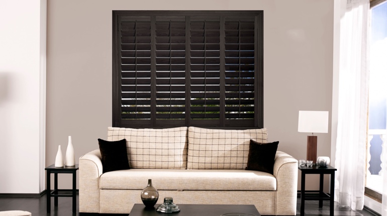 Tampa sunroom with stained wood shutters.